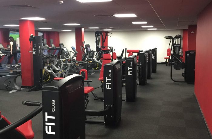 Resistance machines and cardio equipment on the Fit Club gym floor