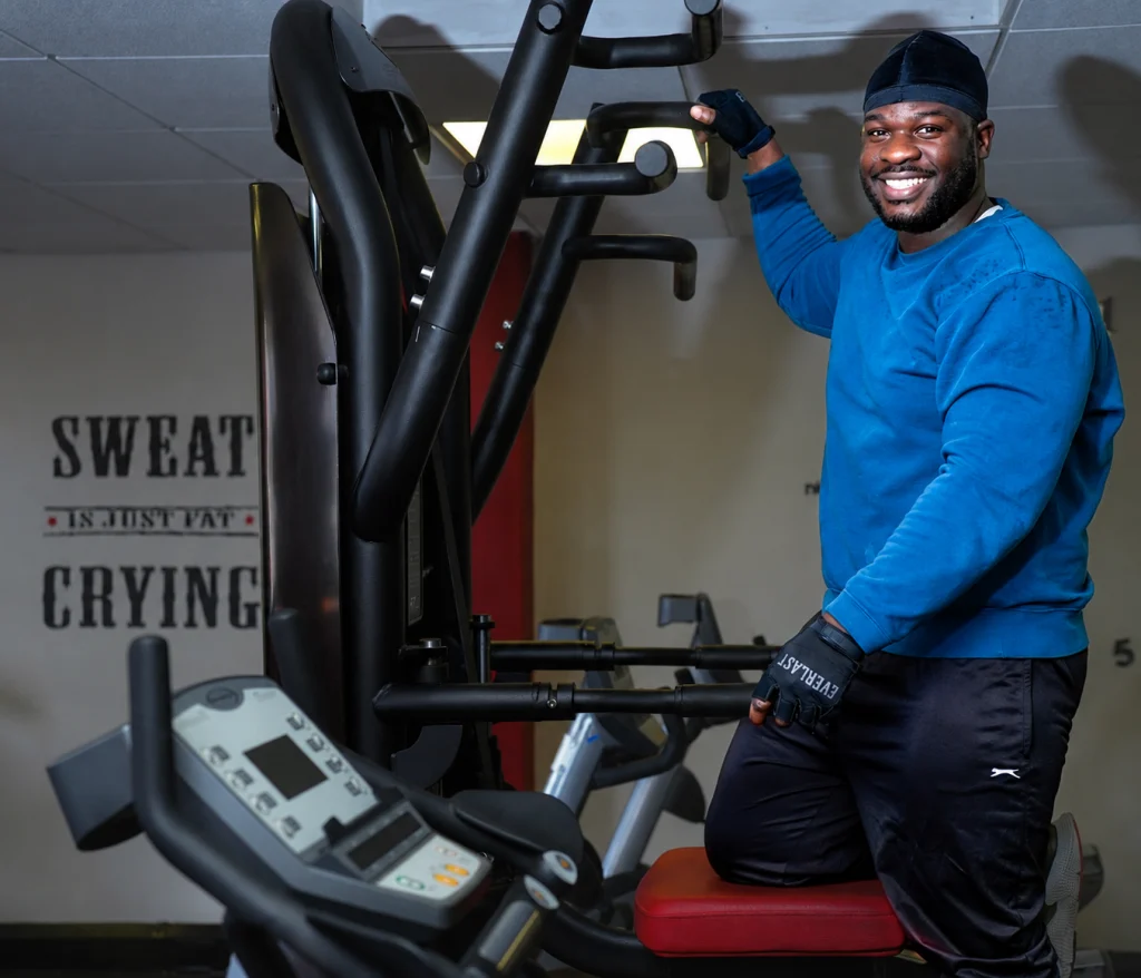 Man posing on an assisted chin-up and dip machine at Fit Club Northwood Hills