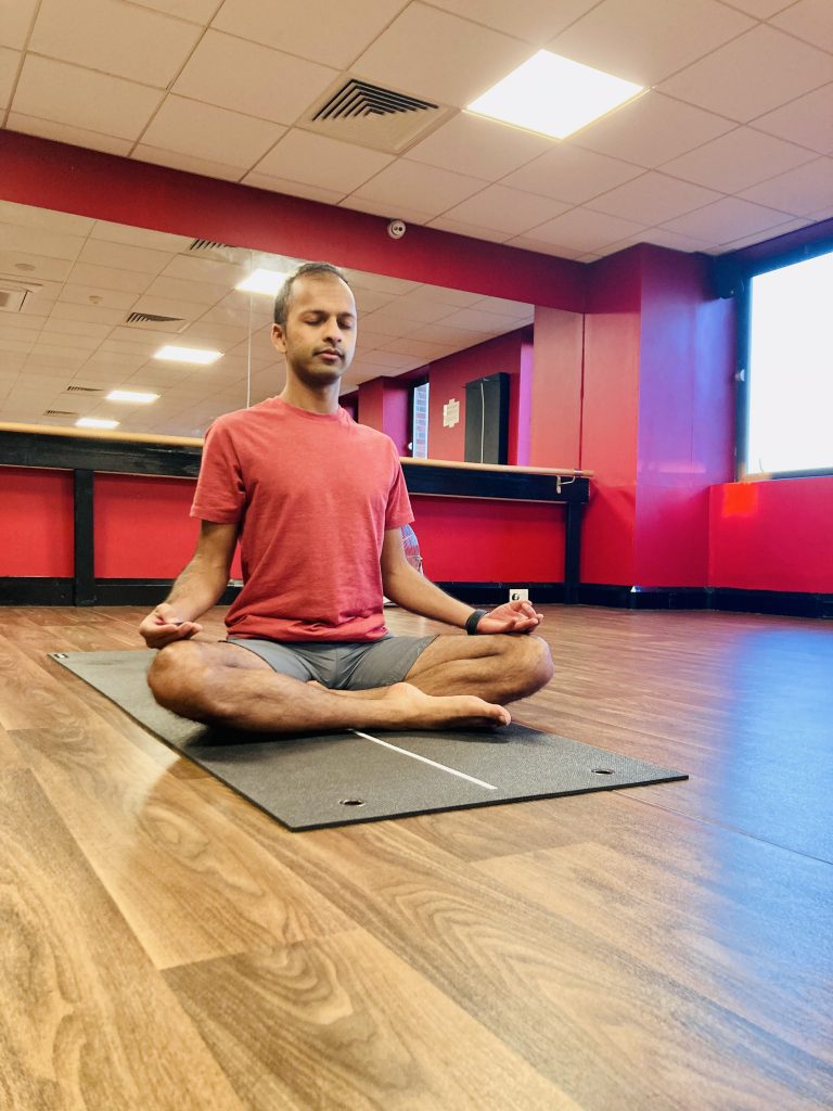Member practising a seated yoga pose in the Fit Club Northwood Hills studio