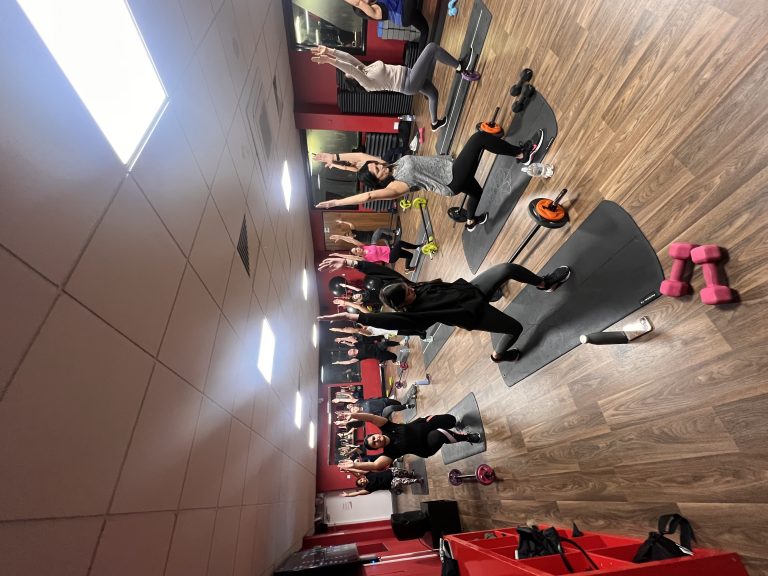 Members performing lunges during a Legs, Glutes and Core class at Fit Club Northwood Hills