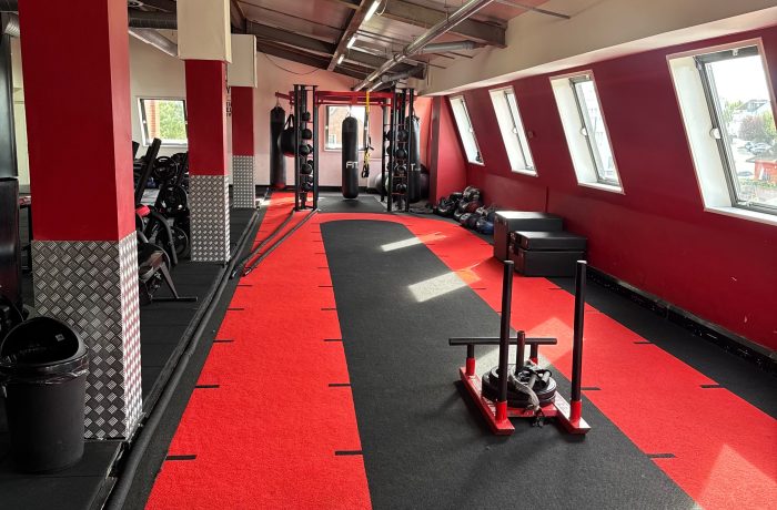 Sprint track with a weighted sled, plyometric boxes and punching bag at Fit Club Northwood Hills